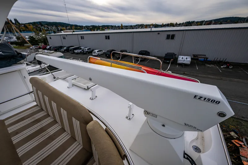 Slide: The Image of 2001 Navigator 61' Pilothouse yacht deck with EZ1500 crane and striped seating. - 73