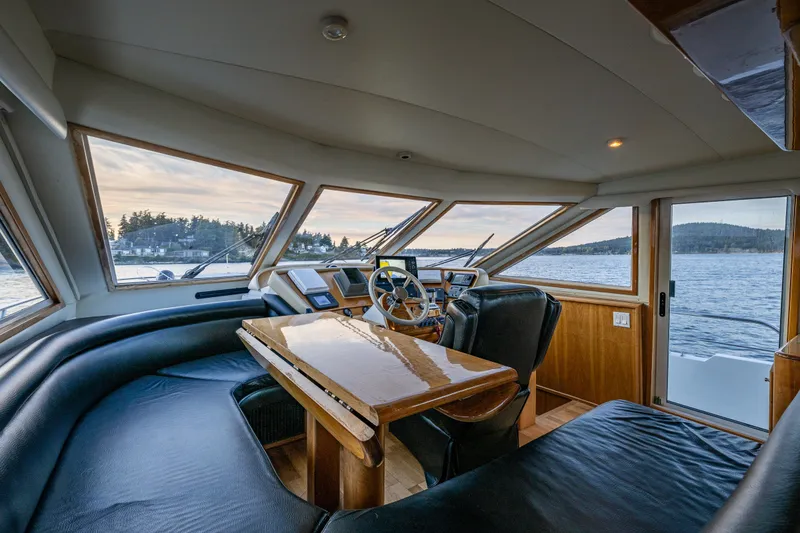 Slide: The Image of Luxurious interior of 2001 Navigator 61' Pilothouse yacht with panoramic windows and elegant seating. - 29