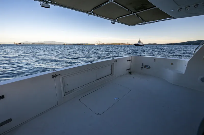 Slide: The Image of Spacious deck view from 2001 Navigator 61' Pilothouse yacht overlooking calm waters. - 88