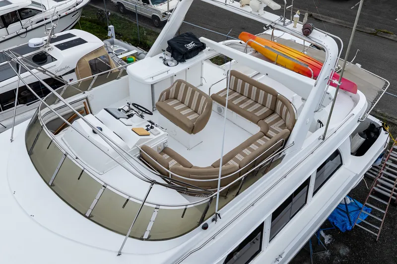 Slide: The Image of 2001 Navigator 61' Pilothouse yacht with spacious deck and seating area. - 46