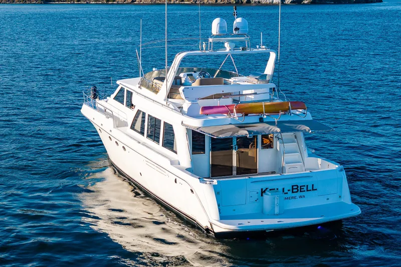 Slide: The Image of 2001 Navigator 61' Pilothouse yacht cruising on blue ocean waters. - 19