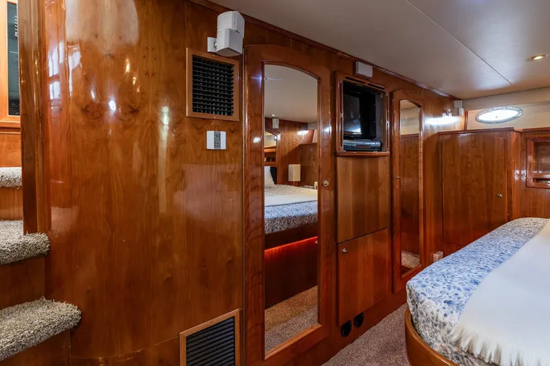 Slide: The Image of Luxurious 2001 Navigator Pilothouse yacht interior with wood paneling and cozy bedroom. - 14