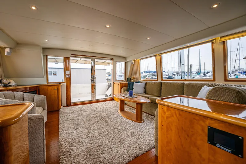 Slide: The Image of Luxurious 2001 Navigator Pilothouse yacht interior with plush seating and marina view. - 2