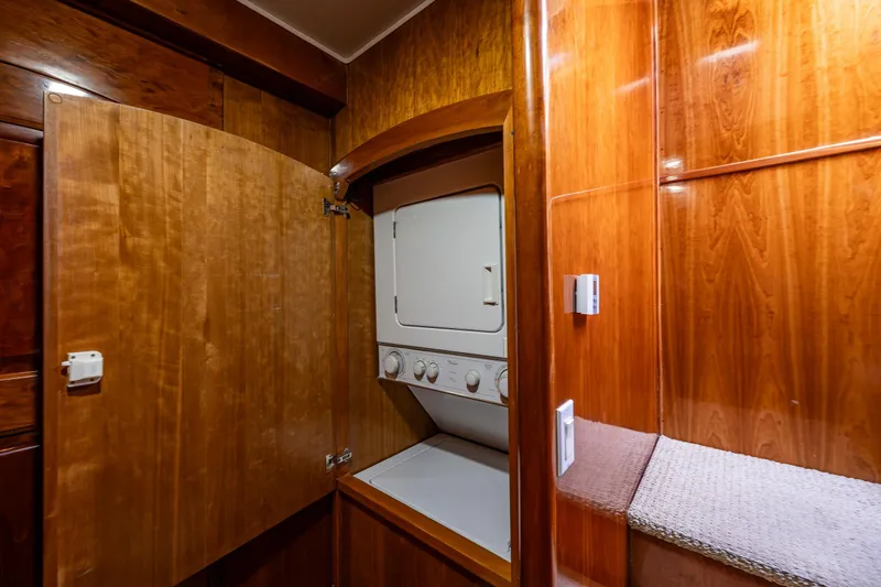 Slide: The Image of Laundry area in 2001 Navigator Pilothouse with wooden cabinetry and stacked washer-dryer. - 20