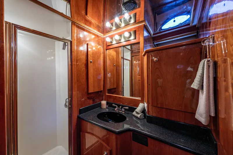 Slide: The Image of Luxurious 2001 Navigator Pilothouse yacht bathroom with wood paneling and modern fixtures. - 22