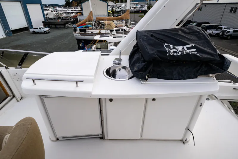 Slide: The Image of Outdoor kitchen area on 2001 Navigator Pilothouse yacht with sink and storage. - 33