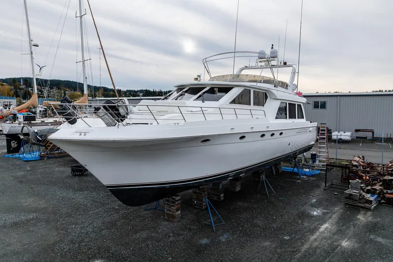 Slide: The Image of 2001 Navigator Pilothouse yacht on dry dock, surrounded by marina equipment. - 35