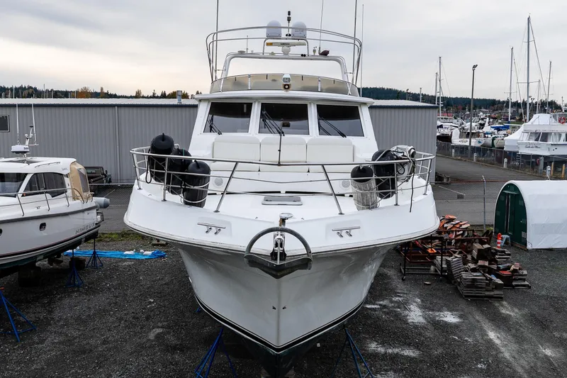 Slide: The Image of 2001 Navigator Pilothouse yacht on dry dock, surrounded by other boats and marina facilities. - 38