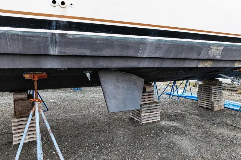 Slide: The Image of 2001 Navigator Pilothouse boat hull on supports, showing keel and stabilizers. - 42