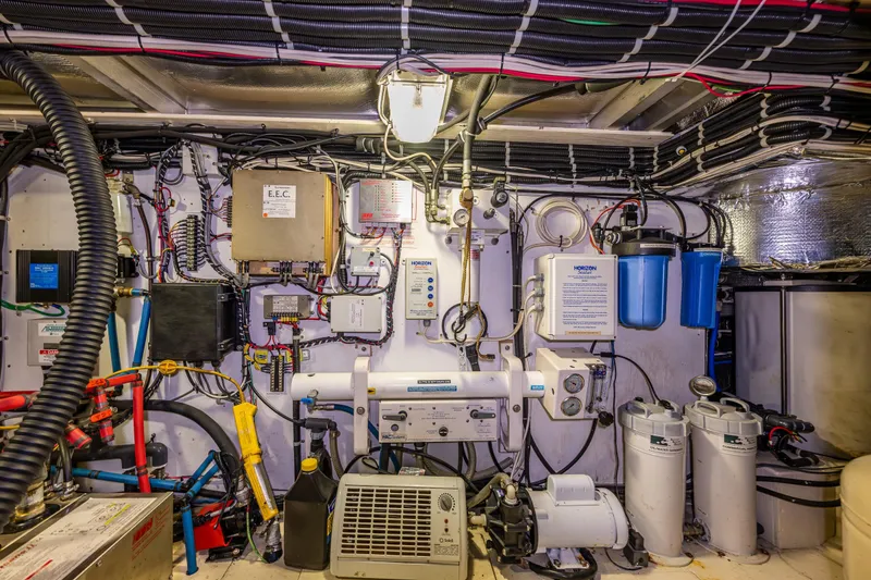 Slide: The Image of Engine room of a 2001 Navigator Pilothouse yacht with complex wiring and equipment. - 45