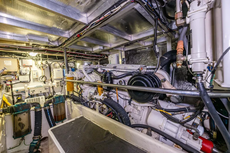 Slide: The Image of Engine room of a 2001 Navigator Pilothouse yacht, showcasing complex machinery and wiring. - 47