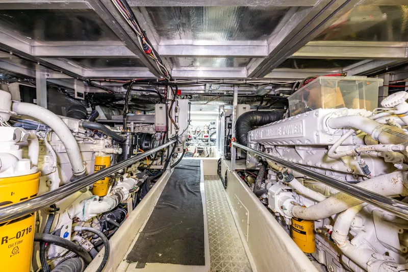Slide: The Image of Engine room of a 2001 Navigator Pilothouse yacht, featuring CAT Marine Power engines. - 49