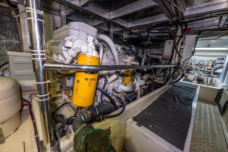 Slide: The Image of Engine room of a 2001 Navigator Pilothouse yacht, featuring detailed machinery and components. - 51