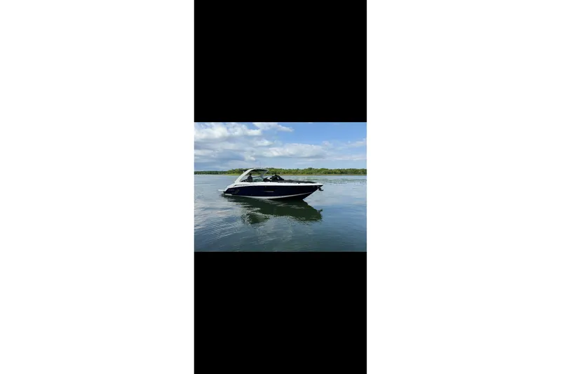 Slide: The Image of 2021 Cruisers Yachts 338 South Beach Edition Bow Rider on calm water. - 1