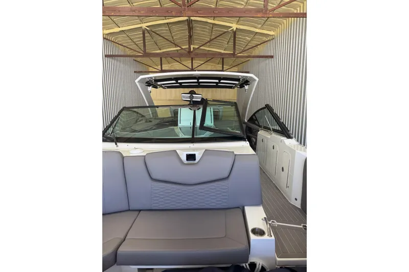 Slide: The Image of 2021 Cruisers Yachts 338 South Beach Edition Bow Rider in storage, featuring sleek interior design. - 13