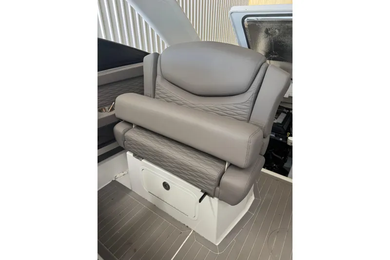 Slide: The Image of 2021 Cruisers Yachts 338 South Beach Edition Bow Rider seat, featuring luxurious gray upholstery. - 15
