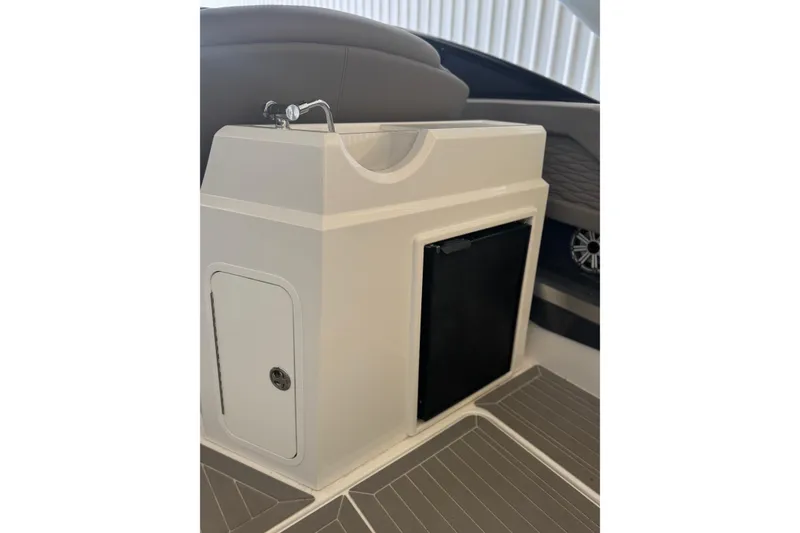 Slide: The Image of 2021 Cruisers Yachts 338 South Beach Edition Bow Rider interior sink and storage area. - 18