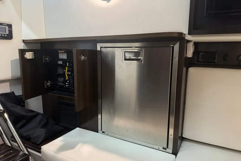 Slide: The Image of 2021 Cruisers Yachts 338 South Beach Edition interior with stainless steel panel and open cabinet. - 23
