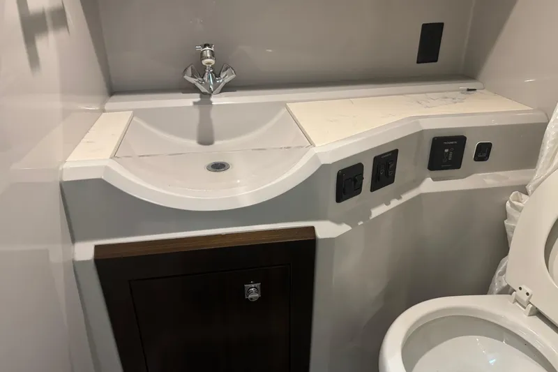 Slide: The Image of 2021 Cruisers Yachts 338 South Beach Edition bathroom with modern sink and toilet. - 25