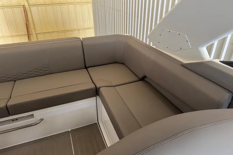Slide: The Image of 2021 Cruisers Yachts 338 South Beach Edition Bow Rider interior seating, featuring sleek gray upholstery. - 7