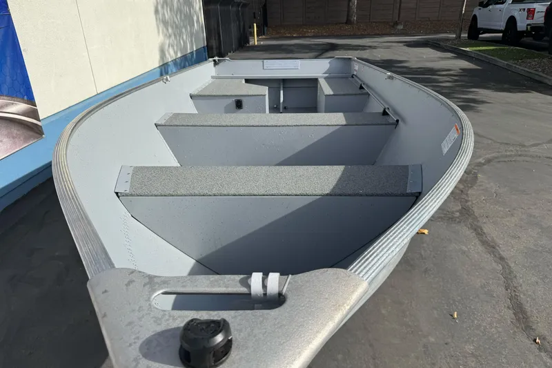 Slide: The Image of 2026 Lund WC-14 aluminum boat, parked outdoors, showcasing interior seating and design. - 3