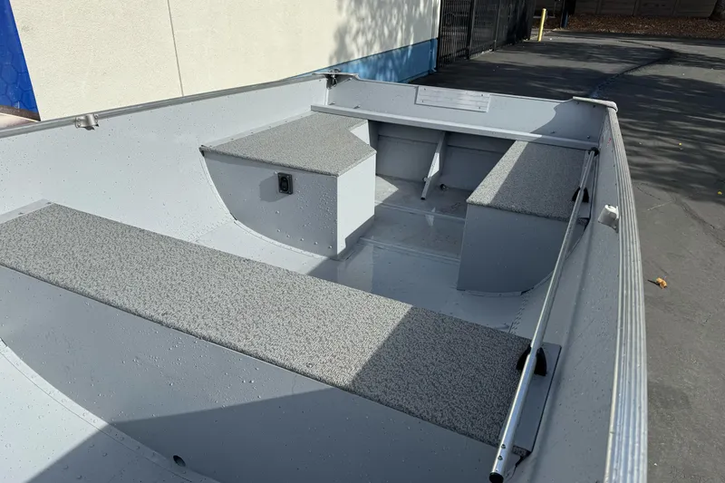 Slide: The Image of 2026 Lund WC-14 boat interior with gray seating and storage compartments. - 4