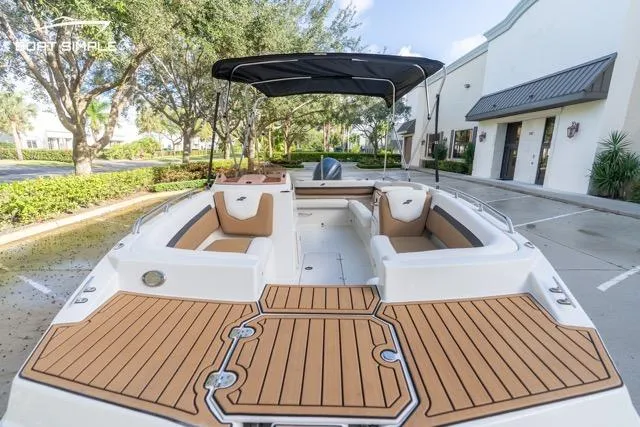 Slide: The Image of 2021 Starcraft SVX 191 OB boat with spacious seating and sleek design in a parking area. - 10