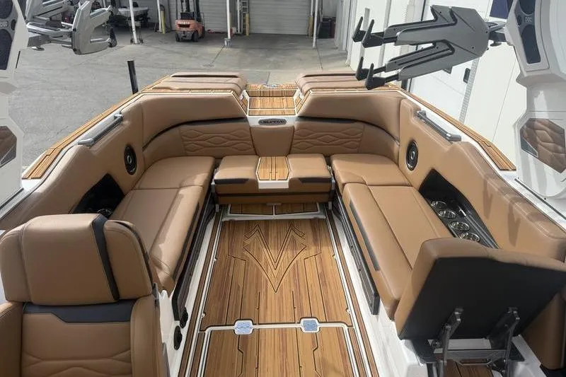 Slide: The Image of Luxurious interior of 2025 Supra SE 575 boat with tan leather seating and wood flooring. - 6