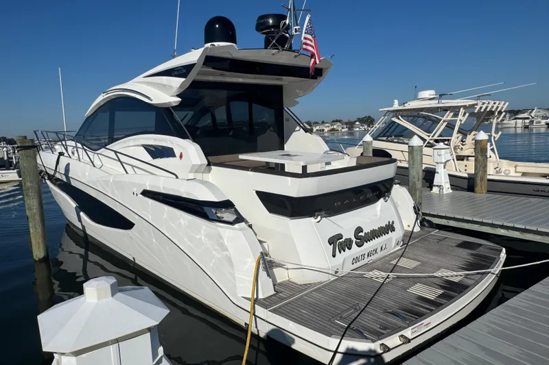 Slide: The Image of Luxury 2017 Galeon 445 HTS yacht docked at marina under clear blue sky. - 12