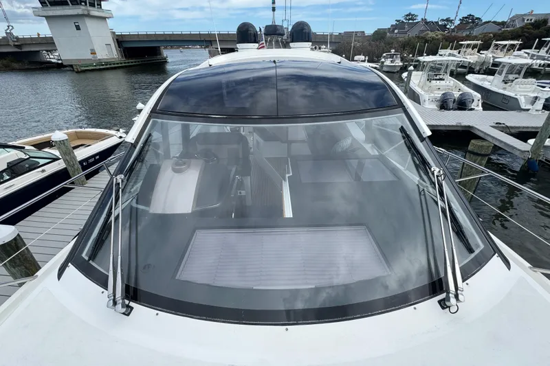 Slide: The Image of 2017 Galeon 445 HTS yacht docked at marina, showcasing sleek design and large windshield. - 17