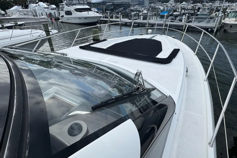 Slide: The Image of 2017 Galeon 445 HTS yacht docked at marina, showcasing sleek design and spacious deck. - 18