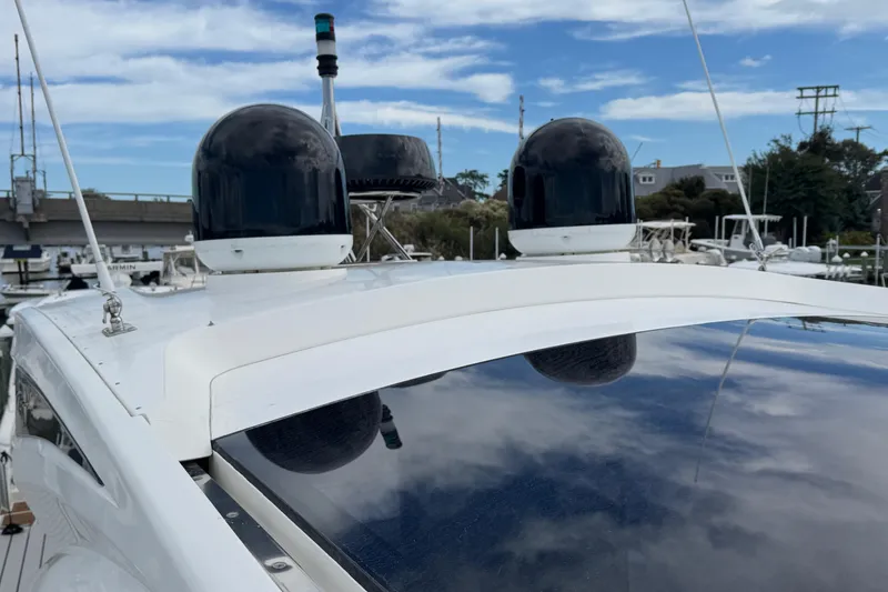 Slide: The Image of Galeon 445 HTS 2017 yacht with radar domes and antennas, docked under a blue sky. - 19