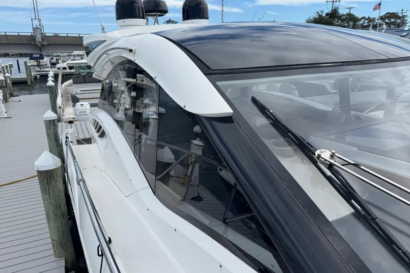 Slide: The Image of 2017 Galeon 445 HTS yacht docked at marina, sleek design, large windows. - 20