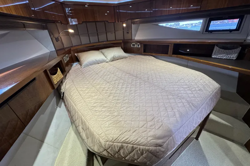 Slide: The Image of Luxurious cabin interior of 2017 Galeon 445 HTS yacht with cozy bed and wooden accents. - 23