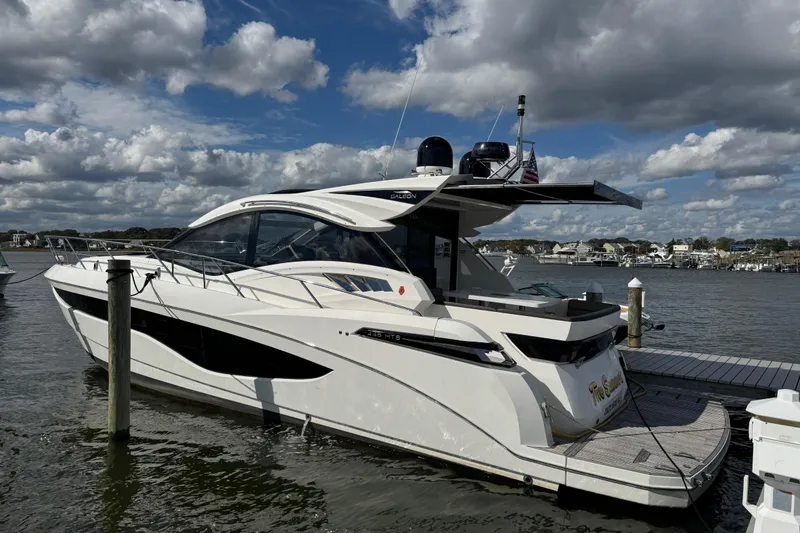 Slide: The Image of 2017 Galeon 445 HTS yacht docked under a partly cloudy sky. - 31