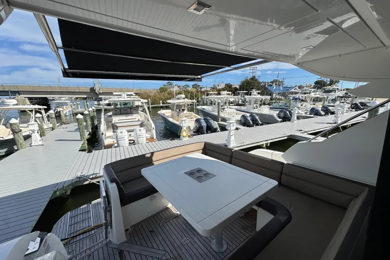 Slide: The Image of Outdoor seating on 2017 Galeon 445 HTS yacht, docked at marina with multiple boats. - 32
