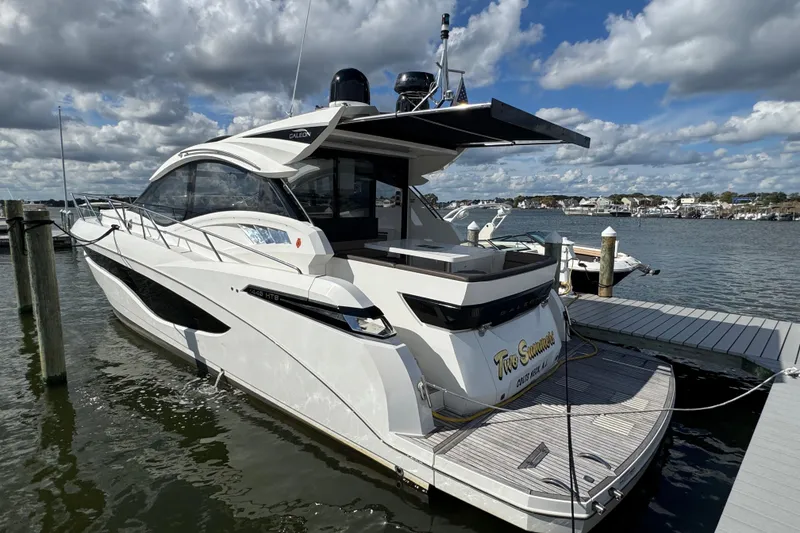 Slide: The Image of Luxury 2017 Galeon 445 HTS yacht docked at marina under cloudy sky. - 34