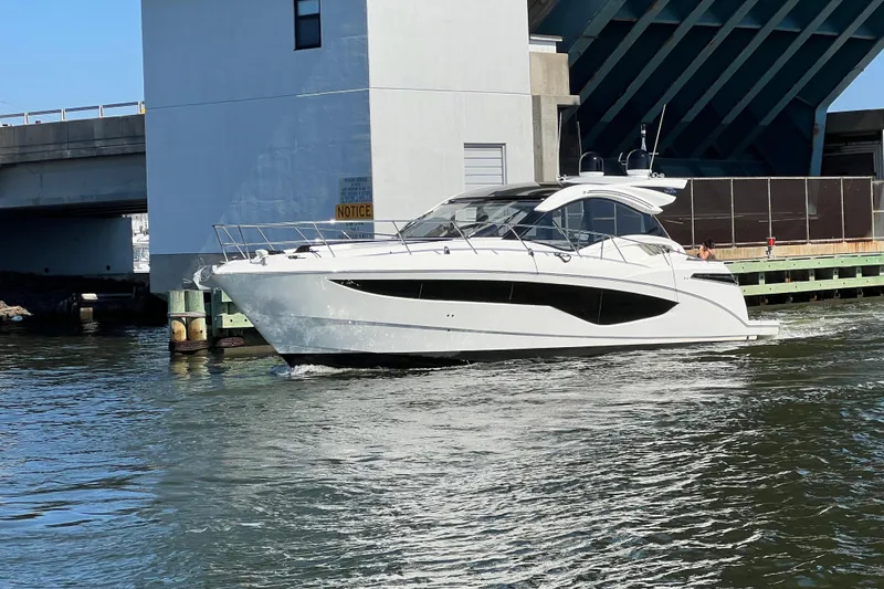 Slide: The Image of 2017 Galeon 445 HTS yacht cruising near a bridge on a sunny day. - 4