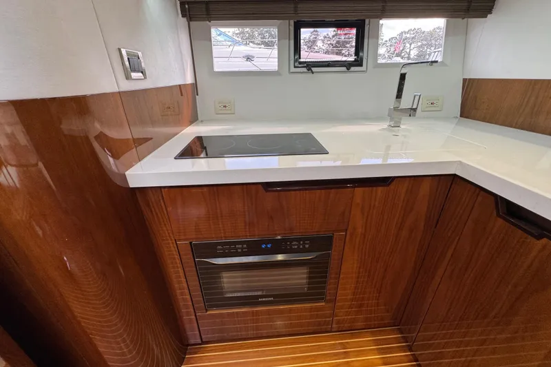Slide: The Image of Modern kitchen in 2017 Galeon 445 HTS yacht with sleek wood cabinetry and appliances. - 42