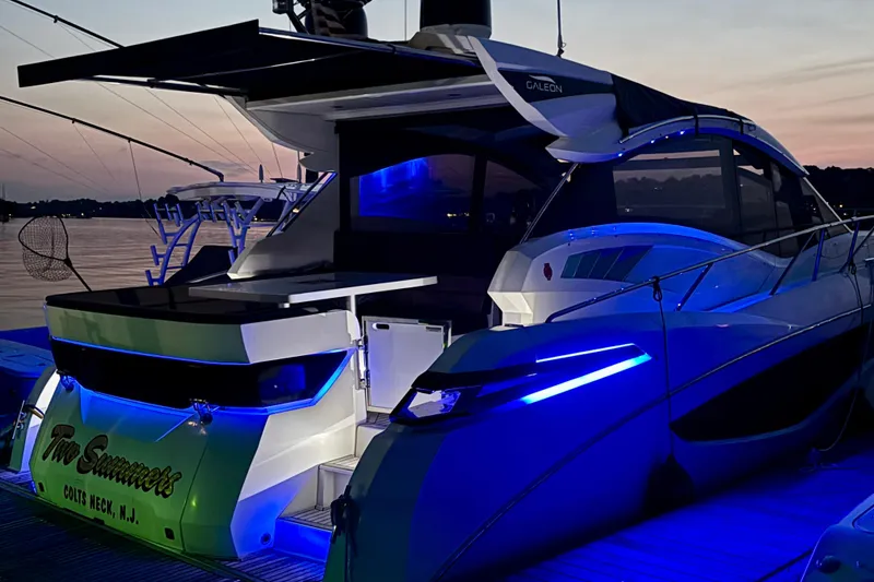 Slide: The Image of 2017 Galeon 445 HTS yacht docked at sunset with blue LED lights. - 6