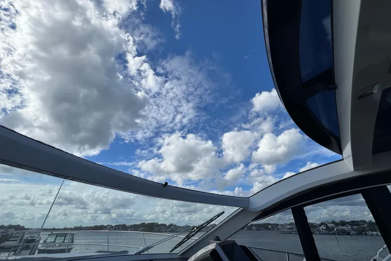 Slide: The Image of 2017 Galeon 445 HTS yacht with open sky view and scattered clouds. - 70