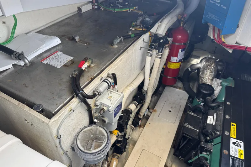 Slide: The Image of Engine room of 2017 Galeon 445 HTS yacht with visible components and fire extinguisher. - 77