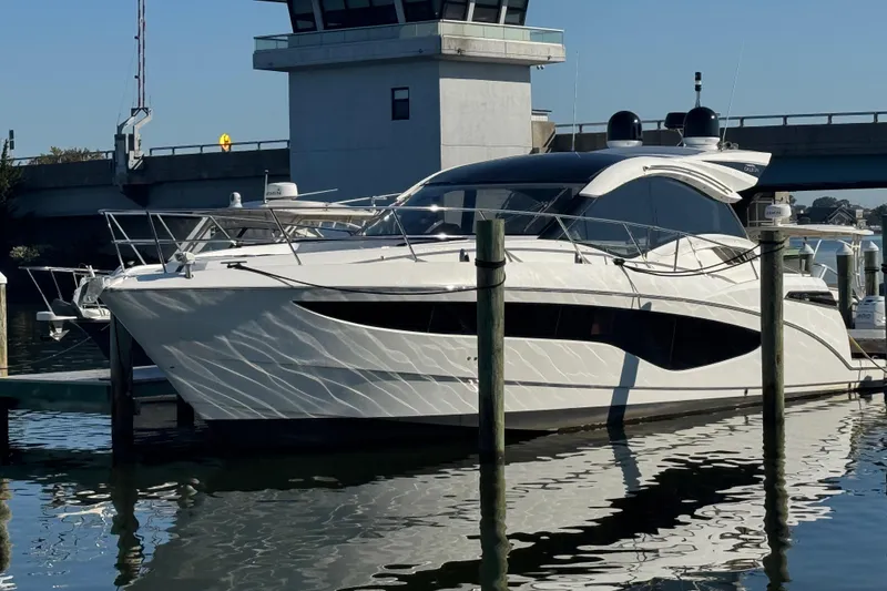 Slide: The Image of Luxury 2017 Galeon 445 HTS yacht docked at marina, reflecting on water. - 9