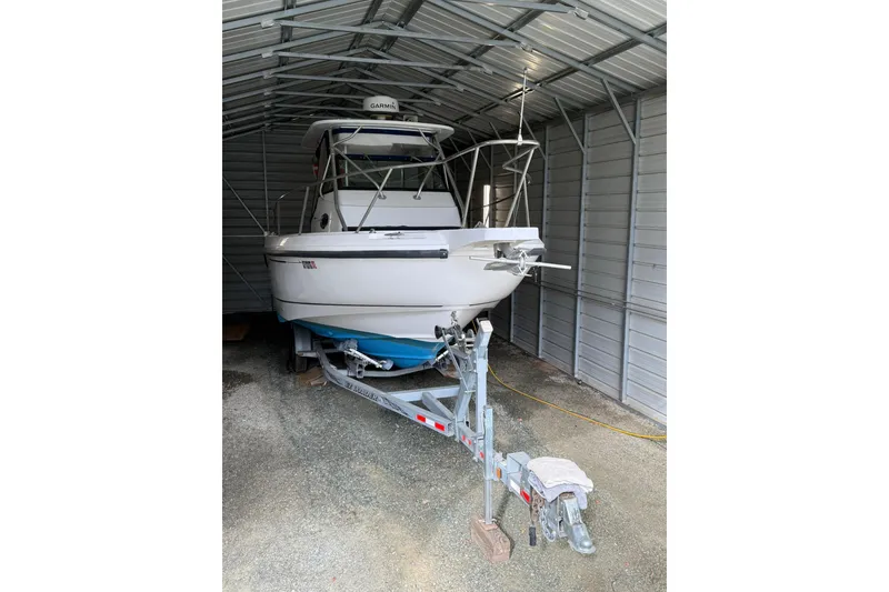 The Image of 2000 Boston Whaler 28 Outrage boat on trailer in metal storage shed. - 0