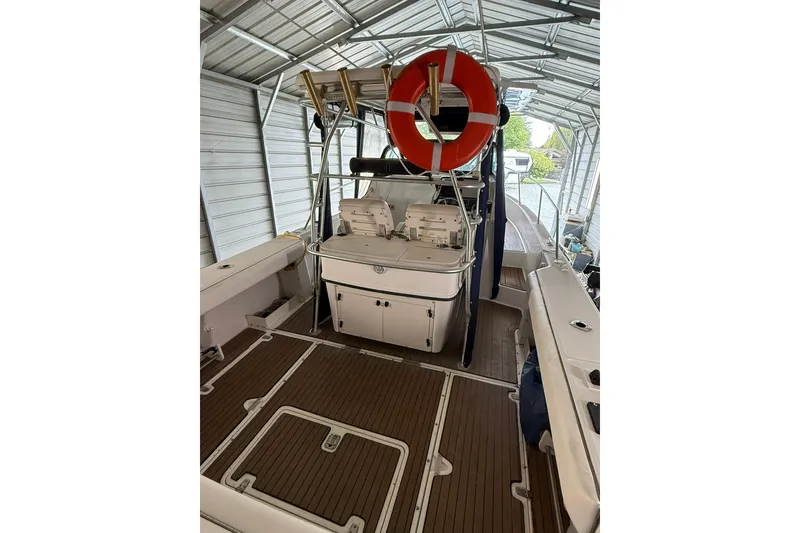 Slide: The Image of 2000 Boston Whaler 28 Outrage boat interior with wooden deck and life preserver. - 11