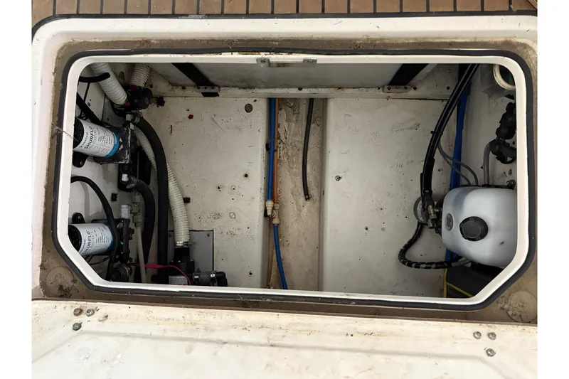 Slide: The Image of Boston Whaler 28 Outrage 2000 boat compartment with pumps and wiring. - 13