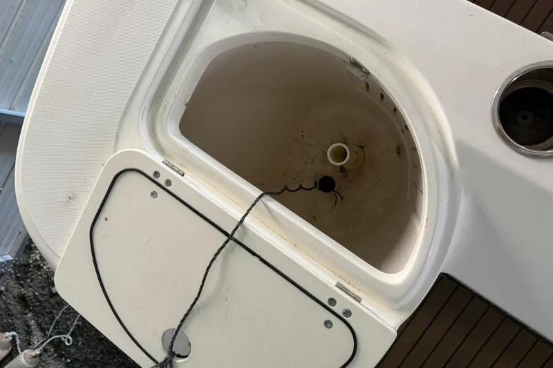 Slide: The Image of Boston Whaler 28 Outrage 2000 boat deck with storage compartment and rope. - 16