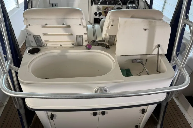 Slide: The Image of Boston Whaler 28 Outrage 2000 model boat interior with sink and storage area. - 17