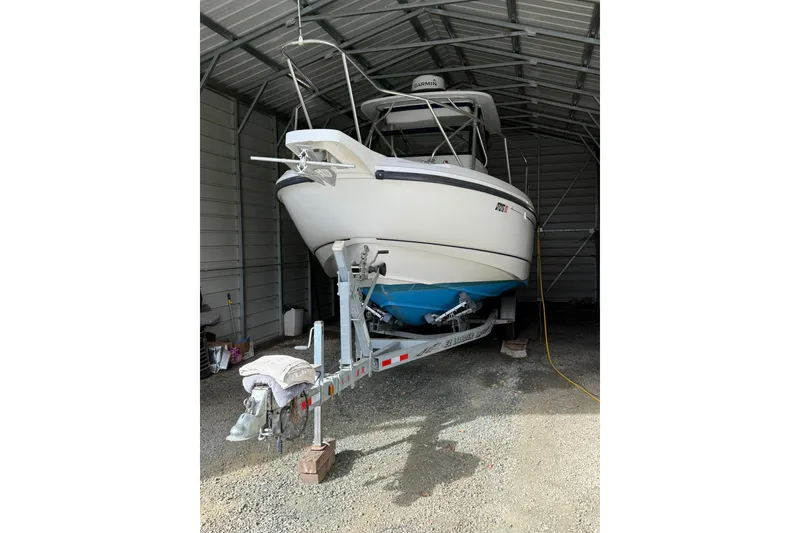 Slide: The Image of 2000 Boston Whaler 28 Outrage boat on trailer in covered storage. - 2