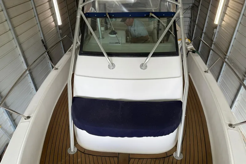 Slide: The Image of 2000 Boston Whaler 28 Outrage boat in storage, featuring teak deck and windshield. - 25
